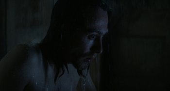Movie still from “X” (2022), directed by Ti West – A person in a dark room; Close Up shot, Low angle