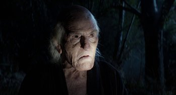 Movie still from “X” (2022), directed by Ti West – An old man with white hair is staring at the camera; Close Up shot, Low angle