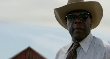 Movie still from “X” (2022), directed by Ti West – An older man wearing a hat and a tie; Close Up shot, Low angle