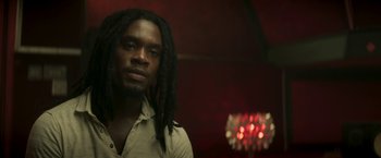 Movie still from “Yardie” (2018), directed by Idris Elba – A person with long dreadlocks; Close Up shot, Low angle