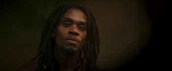 Movie still from “Yardie” (2018), directed by Idris Elba – A person with long dreadlocks; Close Up shot, Low angle