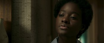 Movie still from “Yardie” (2018), directed by Idris Elba – A person wearing a blue shirt; Close Up shot, Low angle