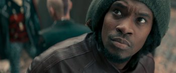 Movie still from “Yardie” (2018), directed by Idris Elba – A person wearing a hat; Close Up shot, Over the shoulder angle