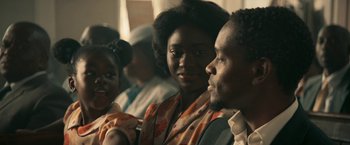 Movie still from “Yardie” (2018), directed by Idris Elba – A man and a woman sitting next to each other; Close Up shot, Over the shoulder angle