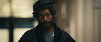 Movie still from “Yardie” (2018), directed by Idris Elba – A person wearing a hat; Close Up shot, Low angle