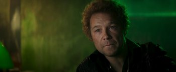 Movie still from “Yardie” (2018), directed by Idris Elba – A person wearing a black shirt; Close Up shot, Low angle