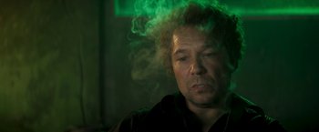 Movie still from “Yardie” (2018), directed by Idris Elba – A person smoking a cigarette in a room; Close Up shot, Low angle