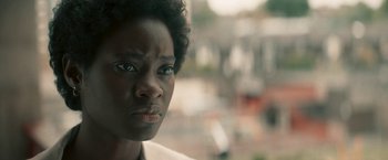 Movie still from “Yardie” (2018), directed by Idris Elba – A person with short black hair; Close Up shot, Over the shoulder angle