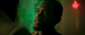 Movie still from “Yardie” (2018), directed by Idris Elba – A person with a beard; Close Up shot, Low angle