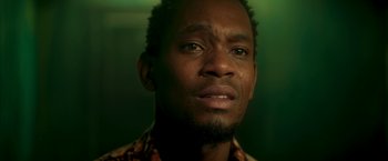 Movie still from “Yardie” (2018), directed by Idris Elba – A person with his eyes wide open; Close Up shot, Low angle