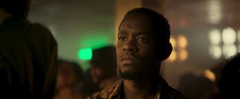 Movie still from “Yardie” (2018), directed by Idris Elba – A person looking at the camera; Close Up shot, Low angle
