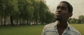 Movie still from “Yardie” (2018), directed by Idris Elba – A person looking up at the sky; Close Up shot, Low angle