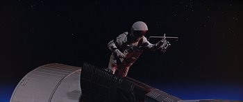 Movie still from “You Only Live Twice” (1967), directed by Lewis Gilbert – A man in a white helmet is jumping over a ramp; Wide shot, Overhead angle