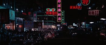 Movie still from “You Only Live Twice” (1967), directed by Lewis Gilbert – A city street with neon signs lit up at night; Extreme Wide shot, High angle