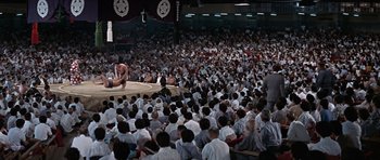 Movie still from “You Only Live Twice” (1967), directed by Lewis Gilbert – A crowd of people watching a sumo match; Extreme Wide shot, High angle
