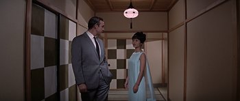 Movie still from “You Only Live Twice” (1967), directed by Lewis Gilbert – A man and a woman standing next to each other in a room; Medium shot, Low angle