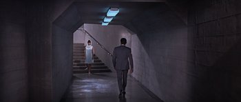 Movie still from “You Only Live Twice” (1967), directed by Lewis Gilbert – A man and a woman walking down a set of stairs; Wide shot, Low angle