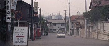 Movie still from “You Only Live Twice” (1967), directed by Lewis Gilbert – A car is driving down the street in a city; Extreme Wide shot, High angle
