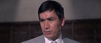 Movie still from “You Only Live Twice” (1967), directed by Lewis Gilbert – A person wearing a suit and tie; Close Up shot, Low angle