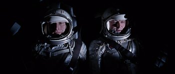 Movie still from “You Only Live Twice” (1967), directed by Lewis Gilbert – Two men in spacesuits are posing for a picture; Medium shot, Overhead angle