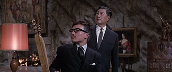 Movie still from “You Only Live Twice” (1967), directed by Lewis Gilbert – Two men in suits and ties standing next to each other; Medium shot, Low angle