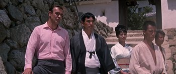 Movie still from “You Only Live Twice” (1967), directed by Lewis Gilbert – A group of men and women standing next to each other; Medium shot, Low angle