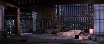 Movie still from “You Only Live Twice” (1967), directed by Lewis Gilbert – A person laying on a bed in a room; Wide shot, Low angle