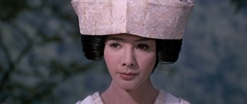 Movie still from “You Only Live Twice” (1967), directed by Lewis Gilbert – A young woman wearing a paper hat; Close Up shot, Low angle