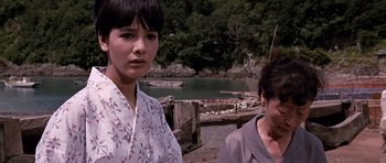 Movie still from “You Only Live Twice” (1967), directed by Lewis Gilbert – Two women standing next to a body of water; Close Up shot, Low angle