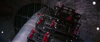 Movie still from “You Only Live Twice” (1967), directed by Lewis Gilbert – A group of men in red jumpsuits standing next to each other; Extreme Wide shot, Low angle