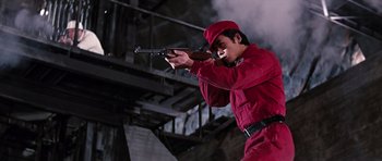 Movie still from “You Only Live Twice” (1967), directed by Lewis Gilbert – A man in a red suit is holding a rifle; Medium shot, Low angle