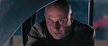 Movie still from “You Only Live Twice” (1967), directed by Lewis Gilbert – A man with a shaved head and a tear in his left eye; Close Up shot, Low angle