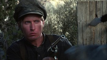Movie still from “Young Guns” (1988), directed by Christopher Cain – A person holding a gun; Close Up shot, Low angle