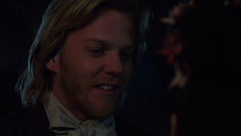 Movie still from “Young Guns” (1988), directed by Christopher Cain – A person wearing a bow tie; Close Up shot, Over the shoulder angle