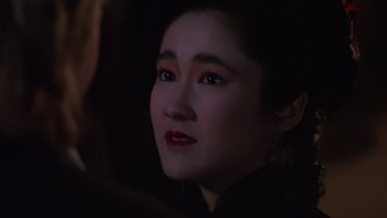 Movie still from “Young Guns” (1988), directed by Christopher Cain – A person wearing a black shirt; Close Up shot, Over the shoulder angle