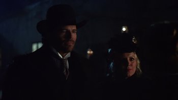 Movie still from “Young Guns” (1988), directed by Christopher Cain – A man and a woman dressed up in the dark; Close Up shot, Over the shoulder angle