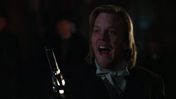 Movie still from “Young Guns” (1988), directed by Christopher Cain – A person holding a cell phone; Close Up shot, Low angle