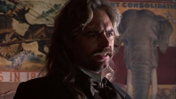 Movie still from “Young Guns” (1988), directed by Christopher Cain – A person wearing a suit and tie; Close Up shot, Low angle