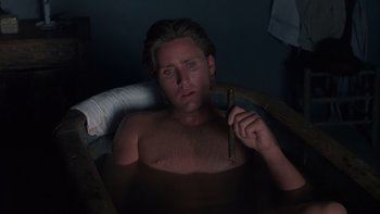 Movie still from “Young Guns” (1988), directed by Christopher Cain – A man sitting in a bathtub holding a cigar; Close Up shot, High angle