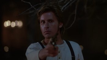 Movie still from “Young Guns” (1988), directed by Christopher Cain – A man holding a knife in his right hand; Close Up shot, Low angle