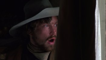 Movie still from “Young Guns” (1988), directed by Christopher Cain – A person wearing a hat; Close Up shot, Low angle