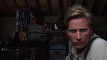Movie still from “Young Guns” (1988), directed by Christopher Cain – A person in a room with suitcases; Close Up shot, Over the shoulder angle