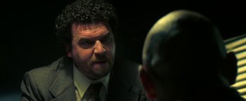 Movie still from “Zeroville” (2019), directed by James Franco – A person wearing a suit and tie; Close Up shot, Over the shoulder angle