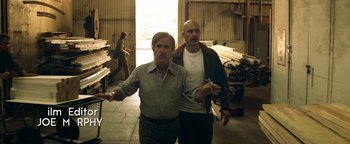 Movie still from “Zeroville” (2019), directed by James Franco – Two men standing next to each other in a building; Medium shot, Low angle