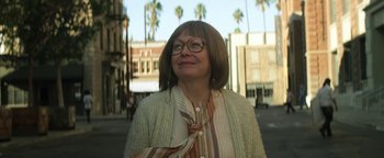 Movie still from “Zeroville” (2019), directed by James Franco – A woman wearing glasses standing on the side of the street; Close Up shot, Low angle