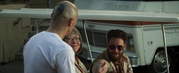 Movie still from “Zeroville” (2019), directed by James Franco – A man and a woman talking to a bald man; Medium shot, Over the shoulder angle