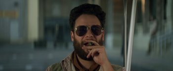 Movie still from “Zeroville” (2019), directed by James Franco – A man with a beard and sunglasses eating a sandwich; Close Up shot, Overhead angle