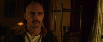 Movie still from “Zeroville” (2019), directed by James Franco – A bald man with a mustache is posing for a picture; Close Up shot, Low angle