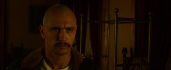 Movie still from “Zeroville” (2019), directed by James Franco – A bald man with a mustache and a goatee; Close Up shot, Low angle