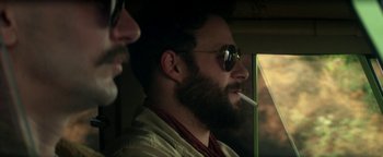 Movie still from “Zeroville” (2019), directed by James Franco – A man smoking a cigarette while sitting next to another man; Close Up shot, Over the shoulder angle